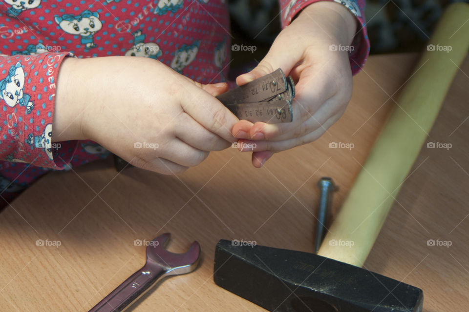 little girl holding tools