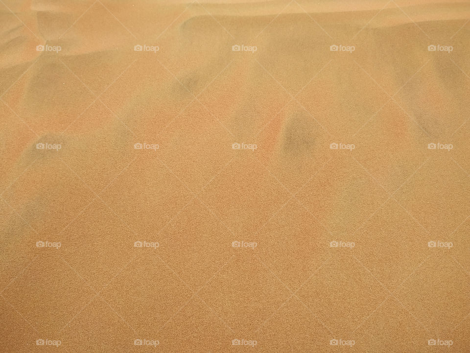 Abstract background of sandy sea on the beach. Wave sand texture