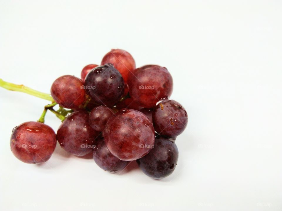 Seedless grapefruit isolated on white background.Water drop on fresh purple grape.