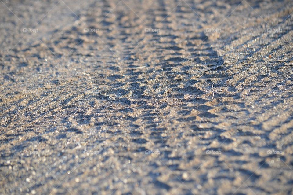 Tire tracks in sand. 