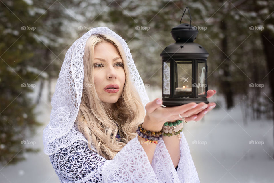 Young woman holding old lantern