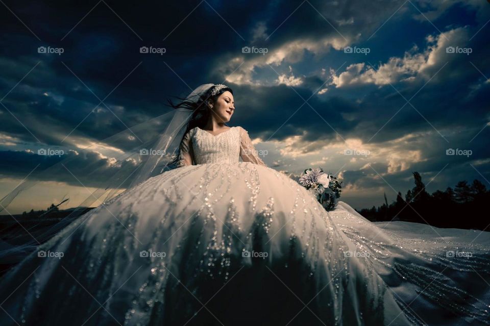 Dramatic clouds and bride