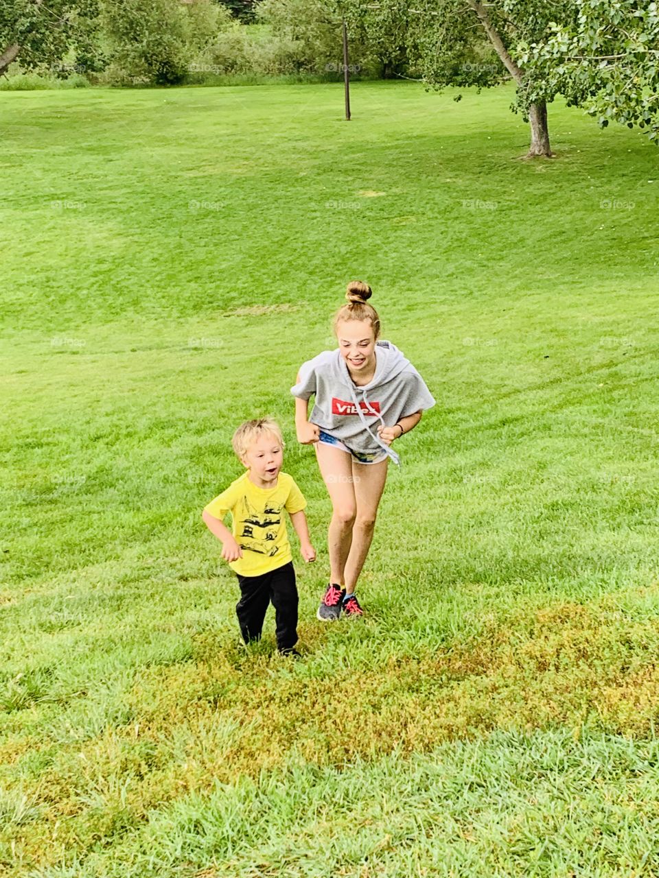 Kids running up a hill 