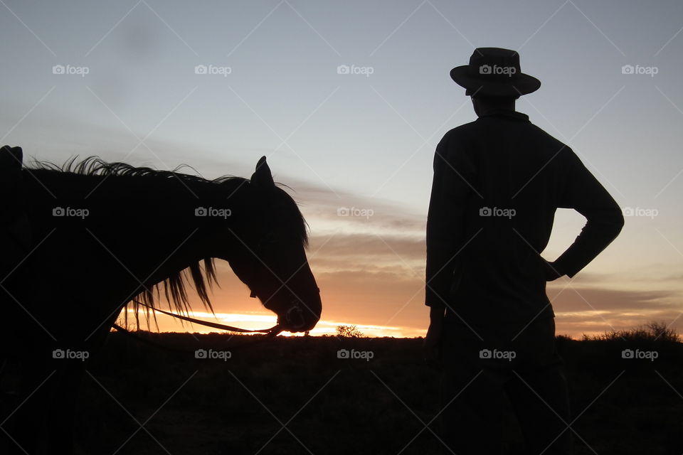 Stoping for the view. Rider stoping the horse ride for a moment to enjoy the beautiful sunset.