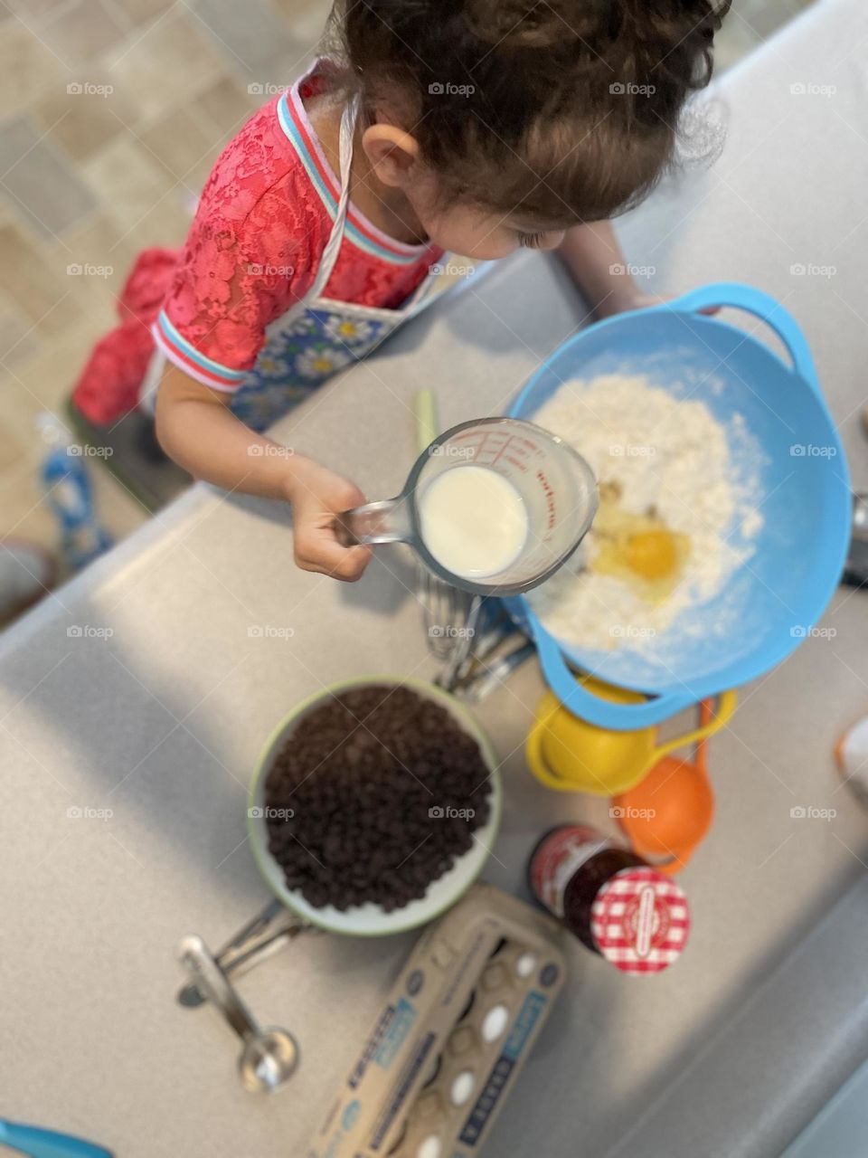 Toddler helps mommy, toddler helps in the kitchen, baking at home, making homemade desserts, mommy and toddler girl spend time together, fun in the kitchen