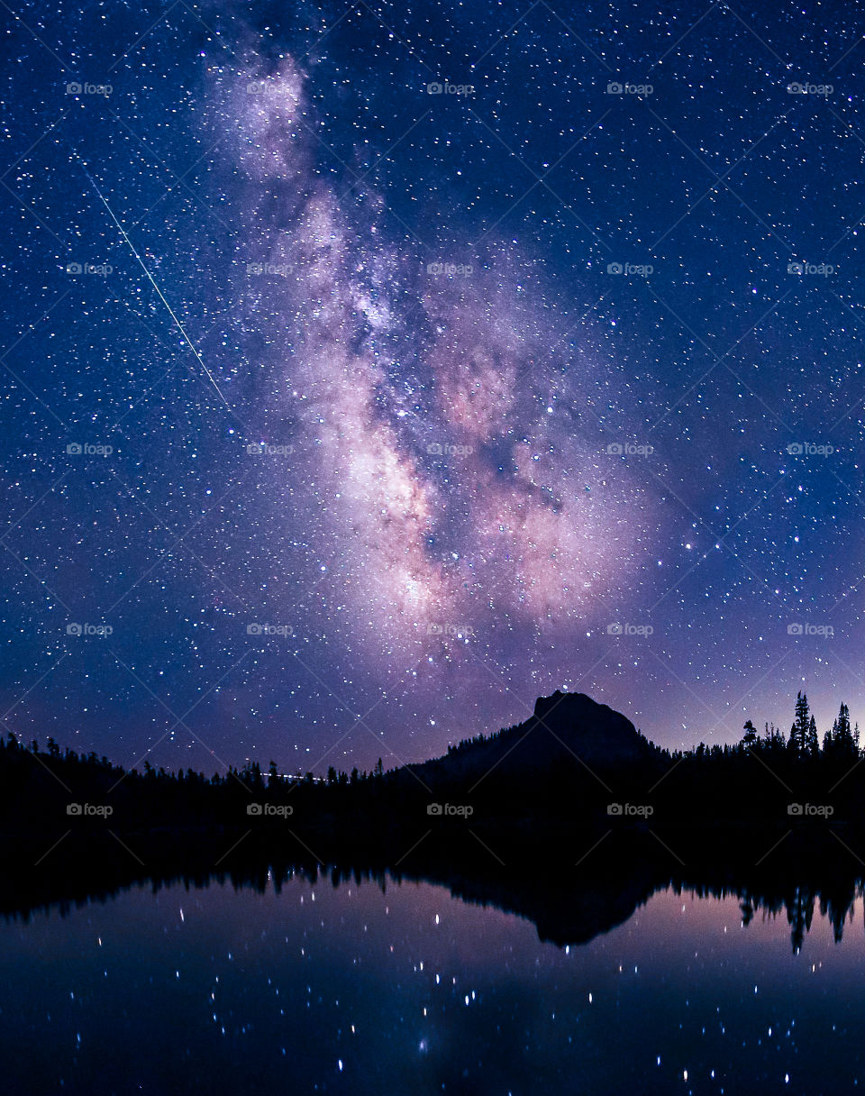 Meteor shower reflections over an alpine lake. 