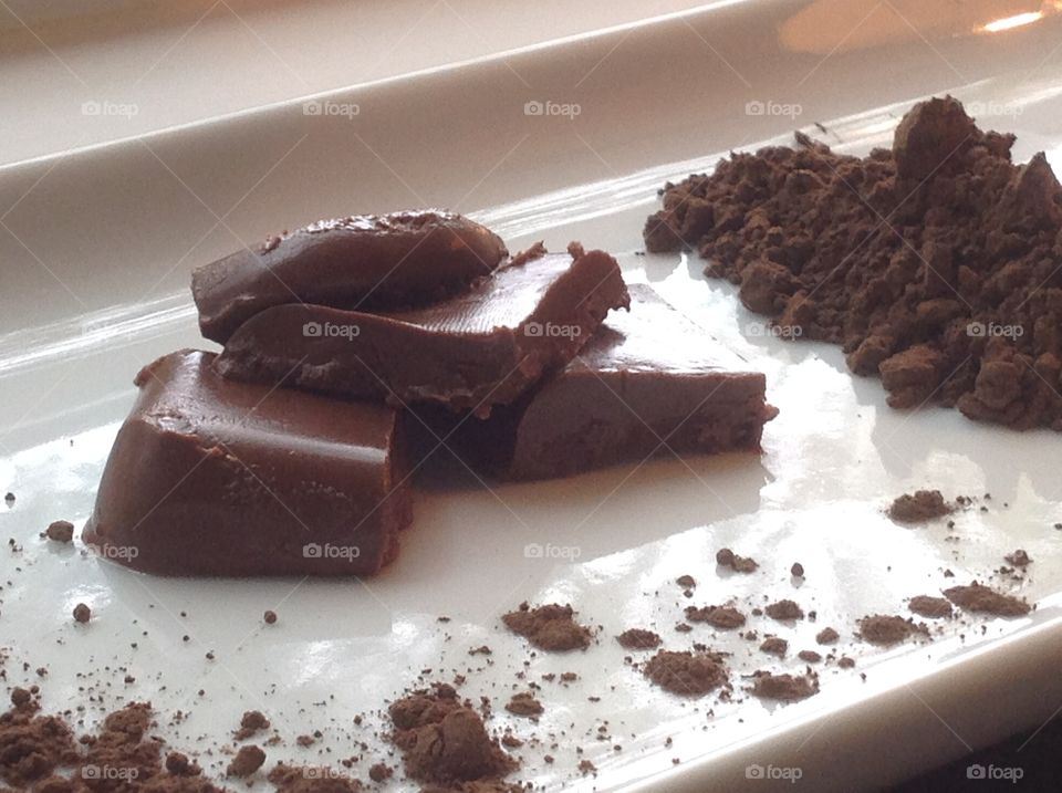 Pieces of fudge with cocoa powder.