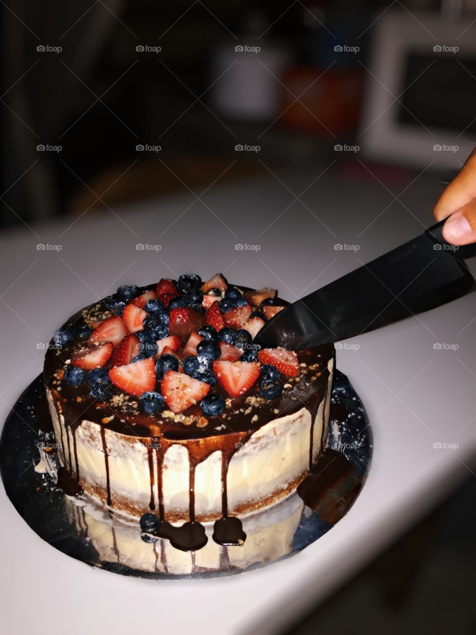 Cutting A Delicious Birthday Cake Decorated With Fruit And Dripping With Chocolate, Food Photography, Dessert Photo