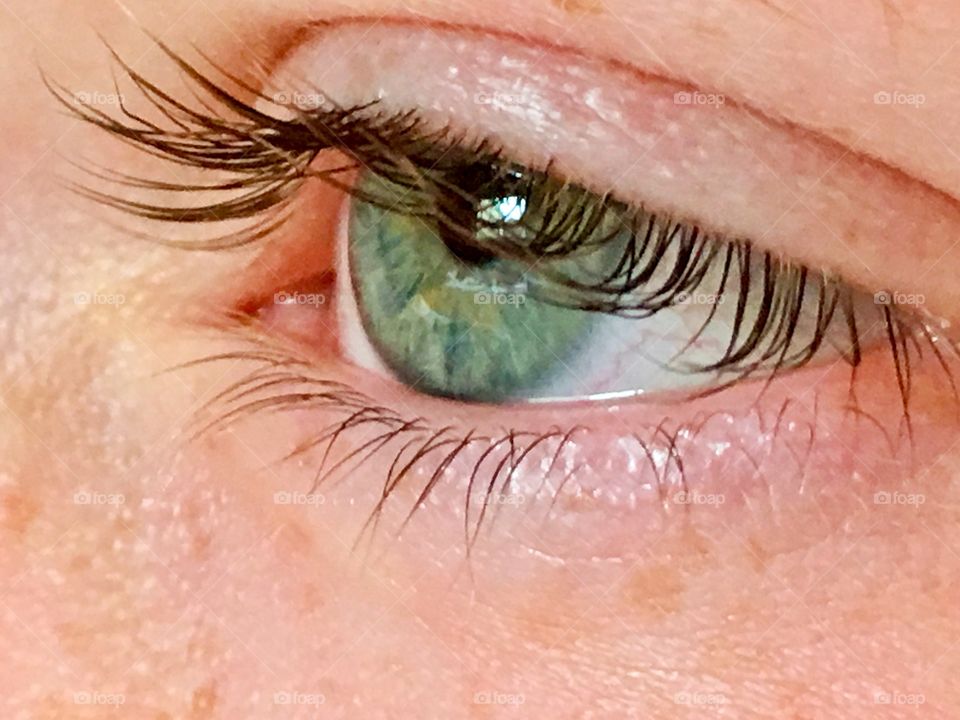 Closeup left eye and eyelid of twelve year old girl 