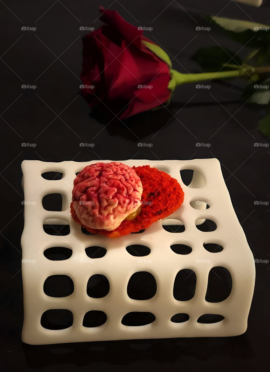 Brain-shaped white chocolate topped with red sprinkles