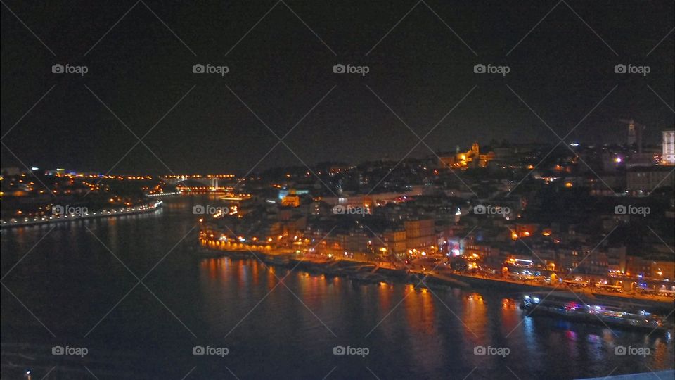 Night view from a high bridge of a  city by the river