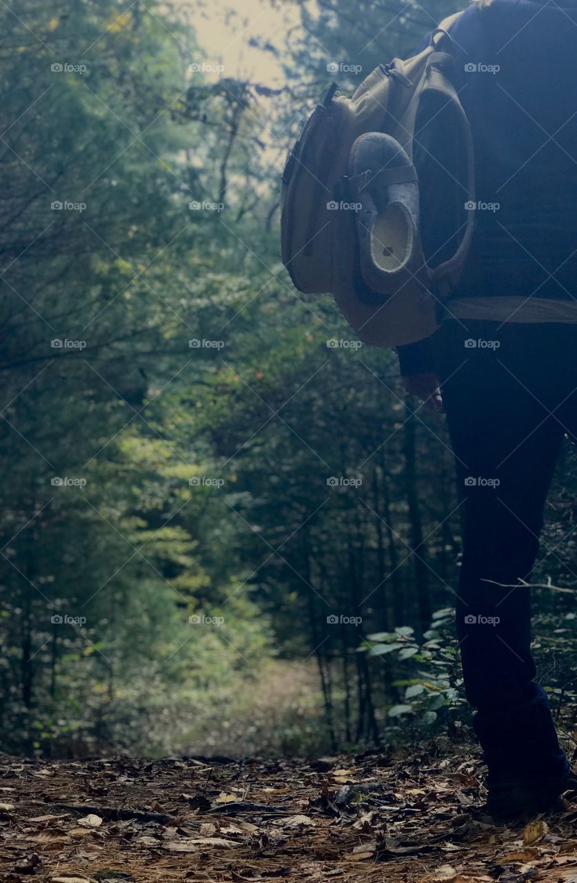 Woman standing on trail with pack at Hacker’s Falls Hiking Trails in Milford, Pennsylvania; Delaware Water Gap Recreation Area, Pike County PA