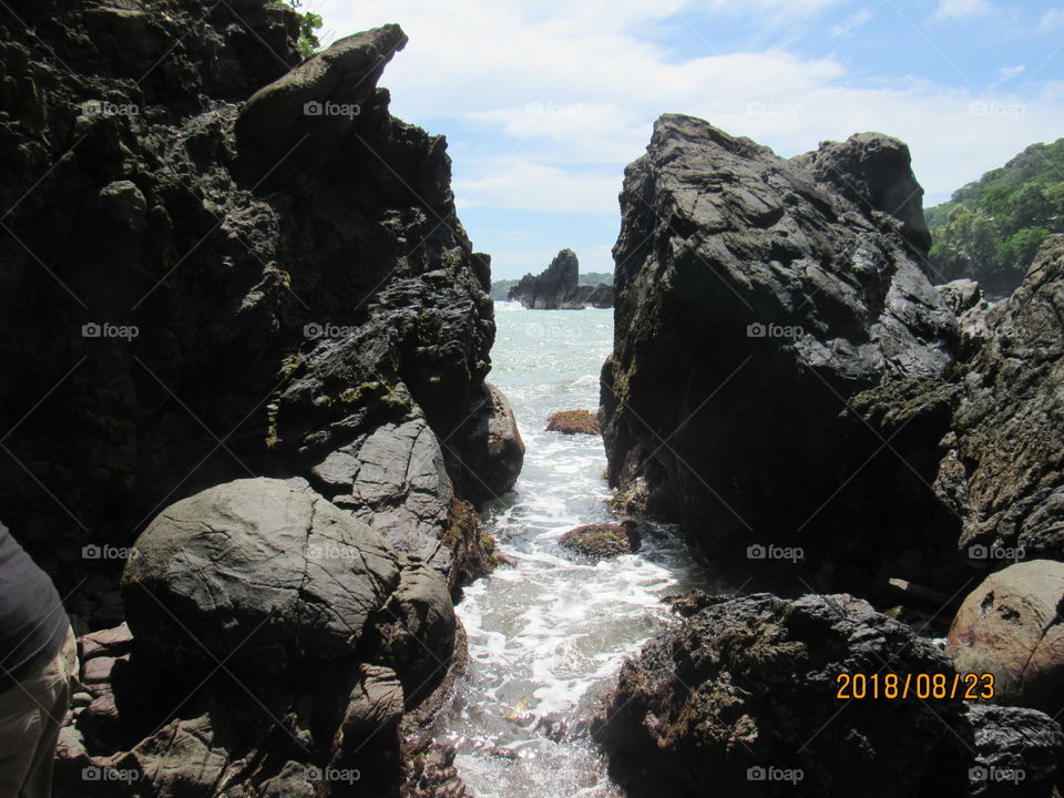 This beautiful scene through the rocks is provided by the twin island Republic of Trinidad and Tobago's nature at its coasts.