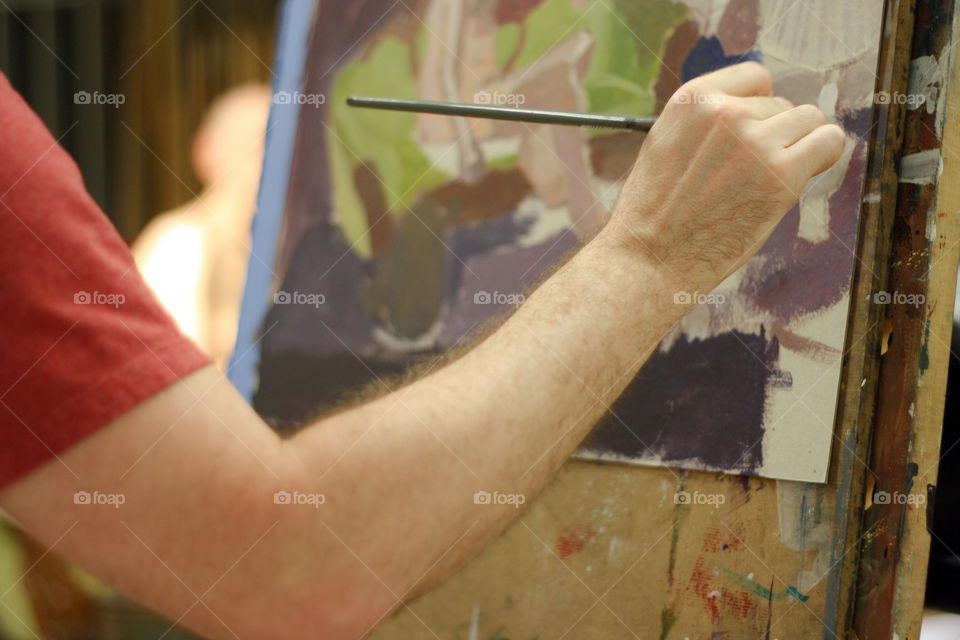 An artist paints in the studio