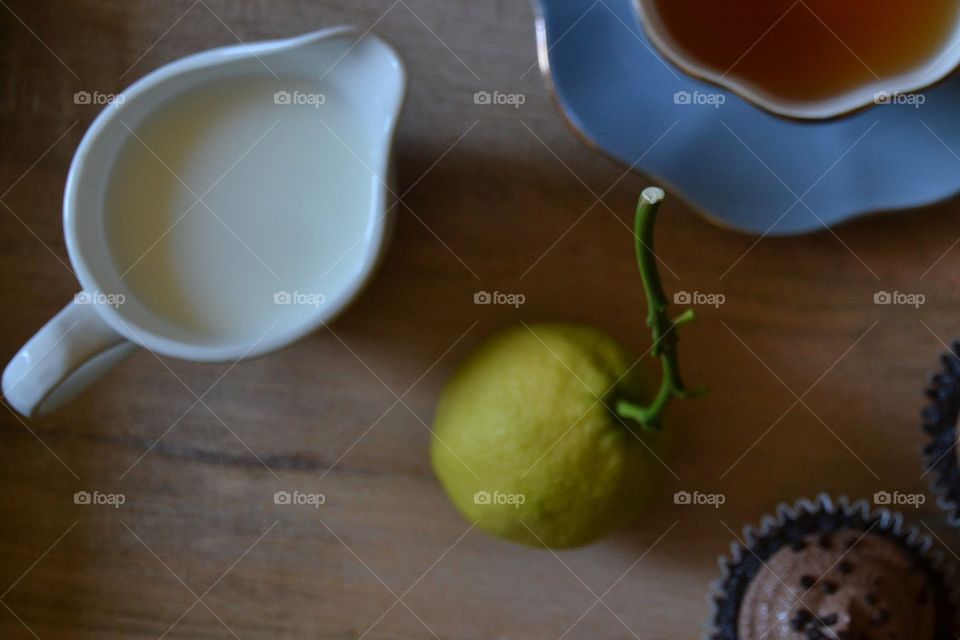 Still life with tea and lemon stem and milk