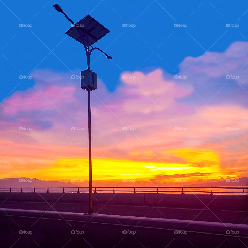 Light pole over the bridge at sunset
