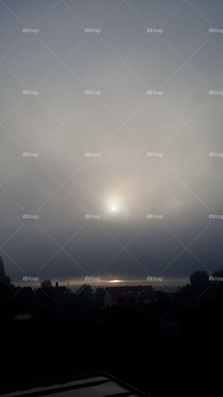 Foggy and grey sunset over lake constance