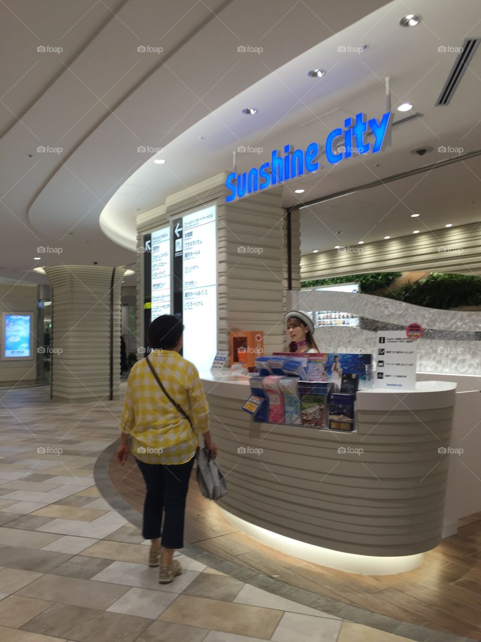 A shopper gets information from the front desk at Sunshine City mall in Tokyo, Japan.
