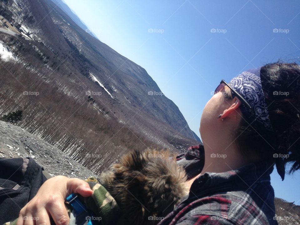 Accomplished and resting at the peak of a snowy hike