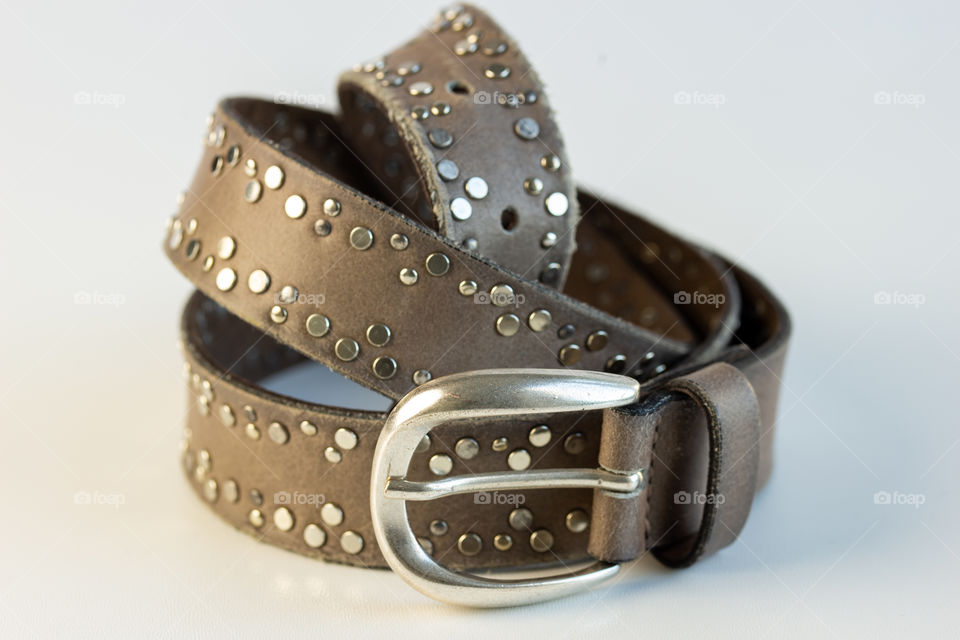 brown leather belt with metal rivets