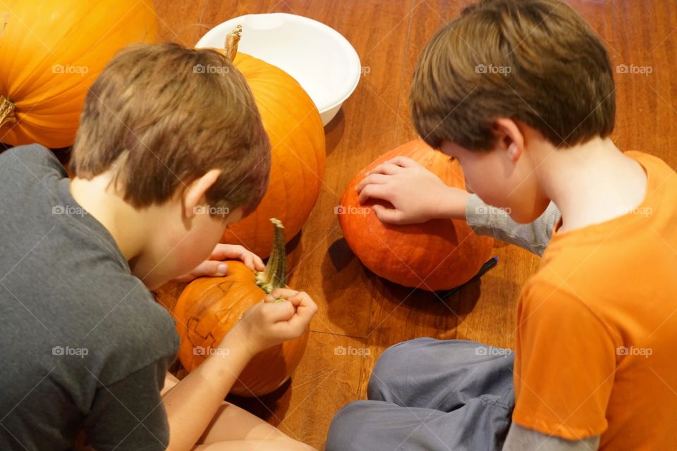 Young Boys Carving Halloween Pumpkins