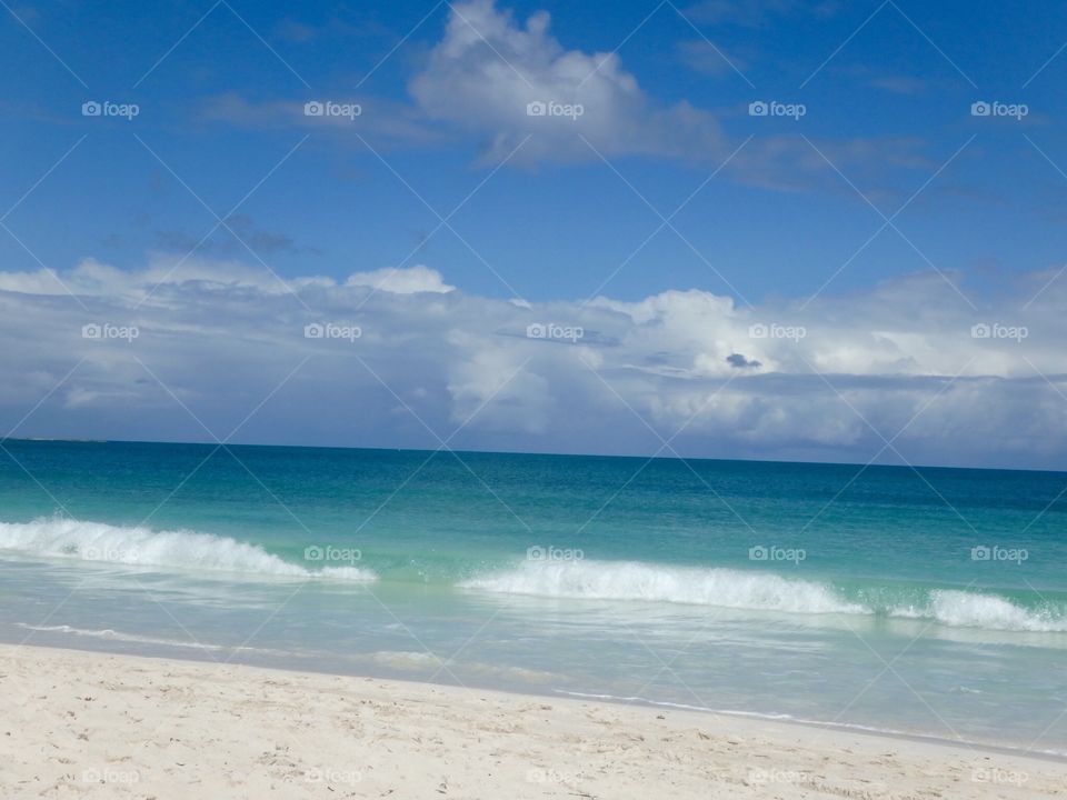 Turquoise seas, sandy beach, crashing waves