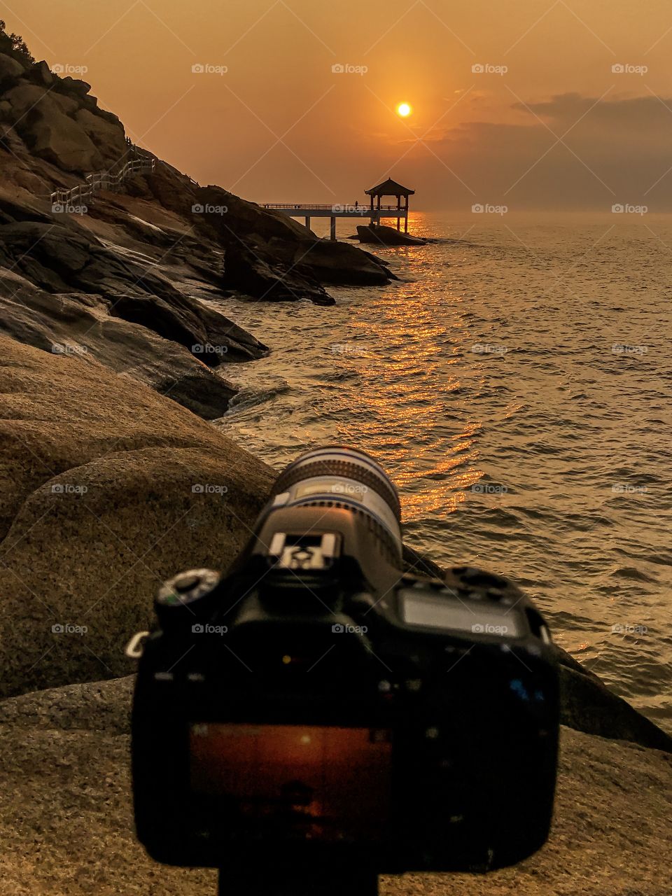 Camera in Action... my Canon Dslr with canon Telephoto lens before the shot... Coastal Sunrise. Mobile shot by iphone 7 plus..Landscape photography.
