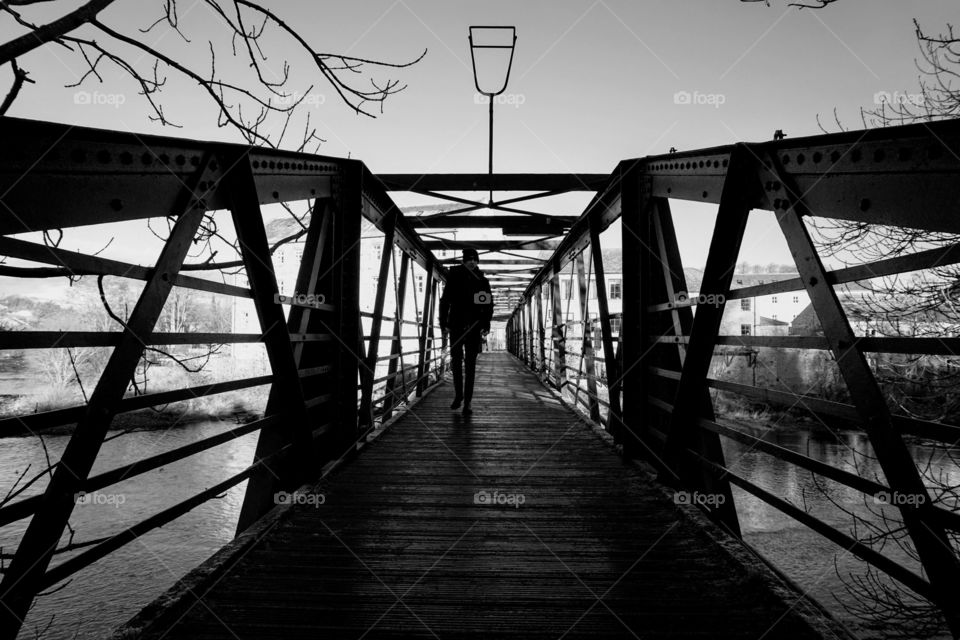 B&W photo of a local bridge with a silhouette of my son in the centre heading towards me