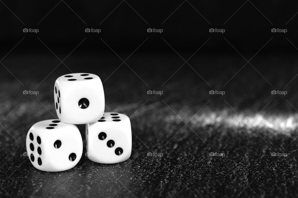 Three dice againts black backgrounds