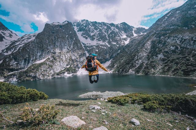 man jumping over lake