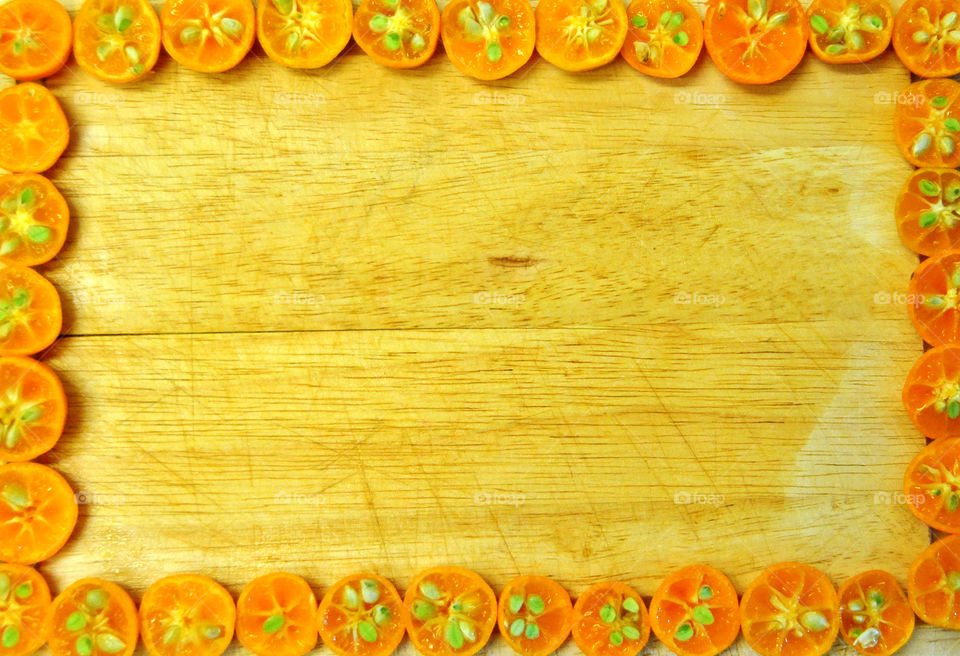 sliced golden yellow lime in wooden cutting board