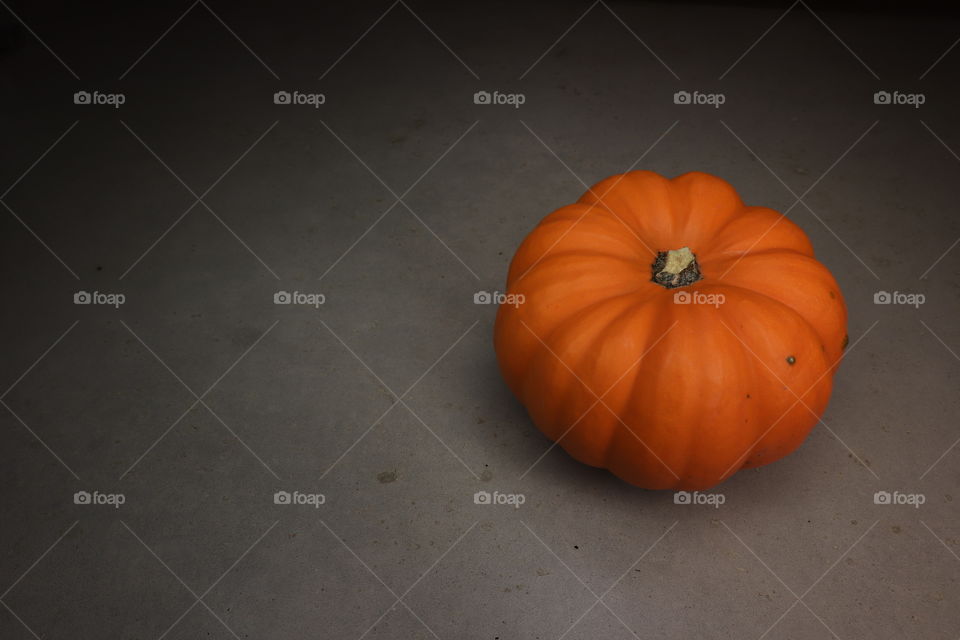 Orange pumpkin with shadowy background, halloween