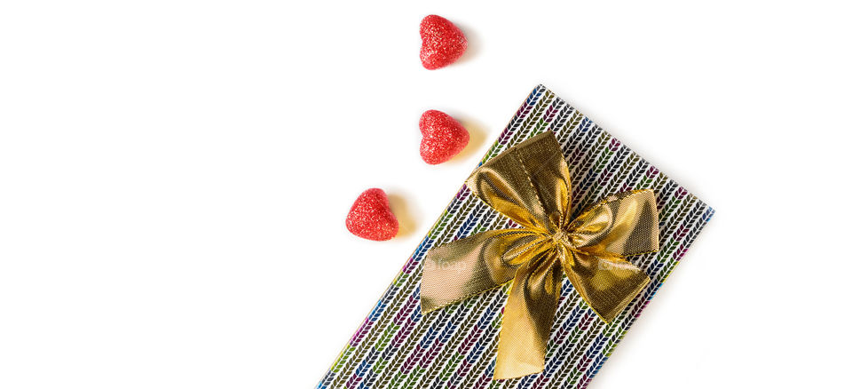 Gift and red hearts on a white background. Valentine's Day.