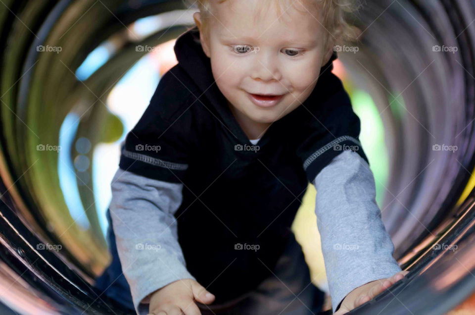 Toddler crawling through a tunnel
