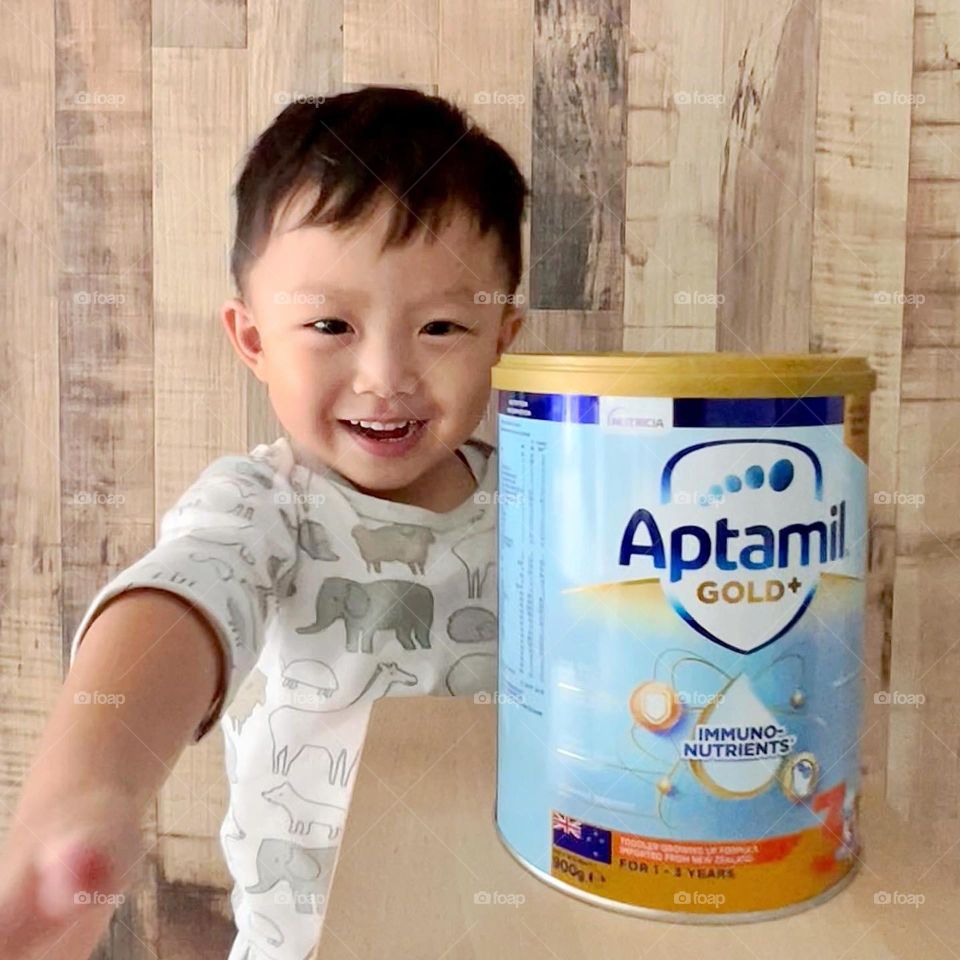 Happy boy with his favourite growing up milk formula 