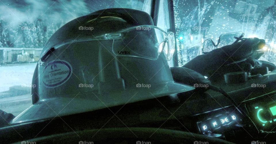 hardhat and safteyglasses. PPE, on the dash of a truck ready to go to work