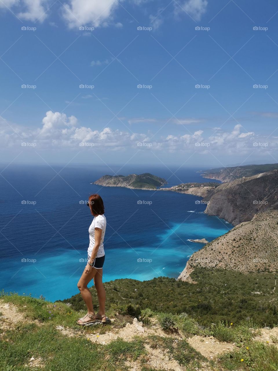 Let's go on a hike. Beautiful Kefalonia, amazing scenery, sunny weather and woman admire the blue sea...Without filters and digital retouching.
