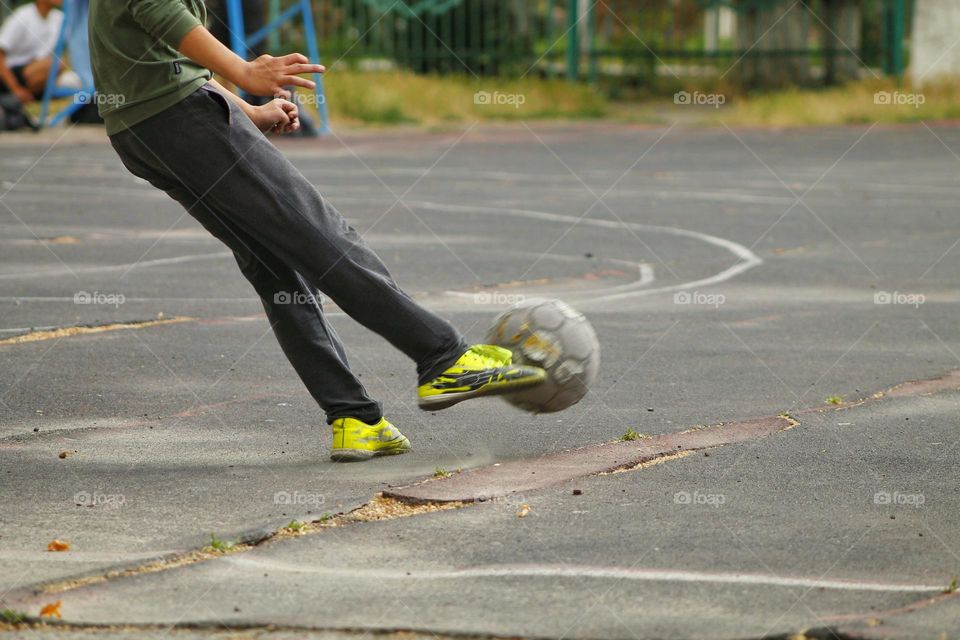 children in the old stadium play football.