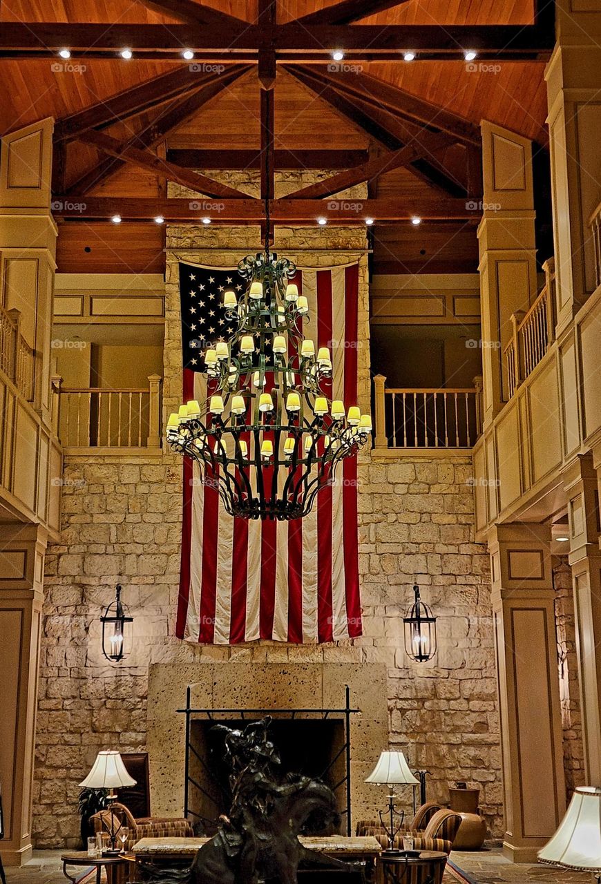 A warmly lit interior space featuring beautiful design elements and a large American flag