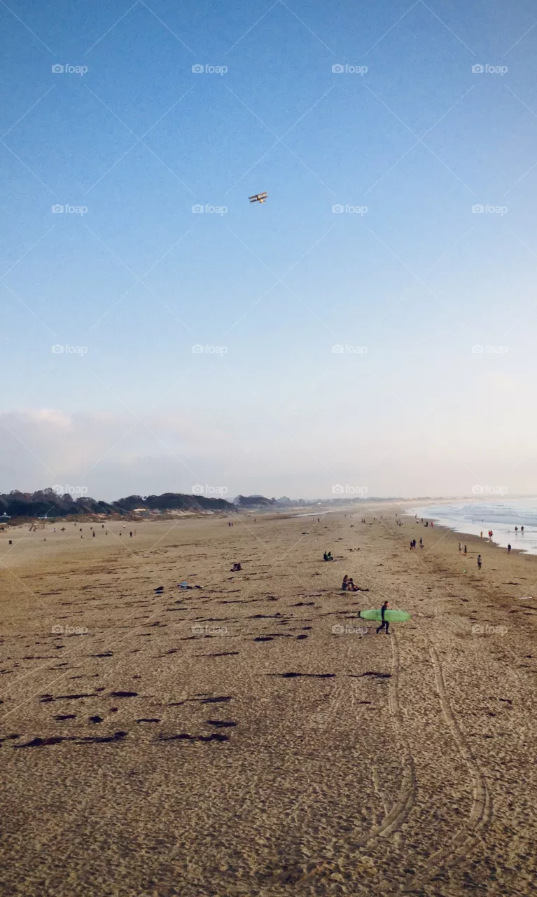 Biplane over beach 