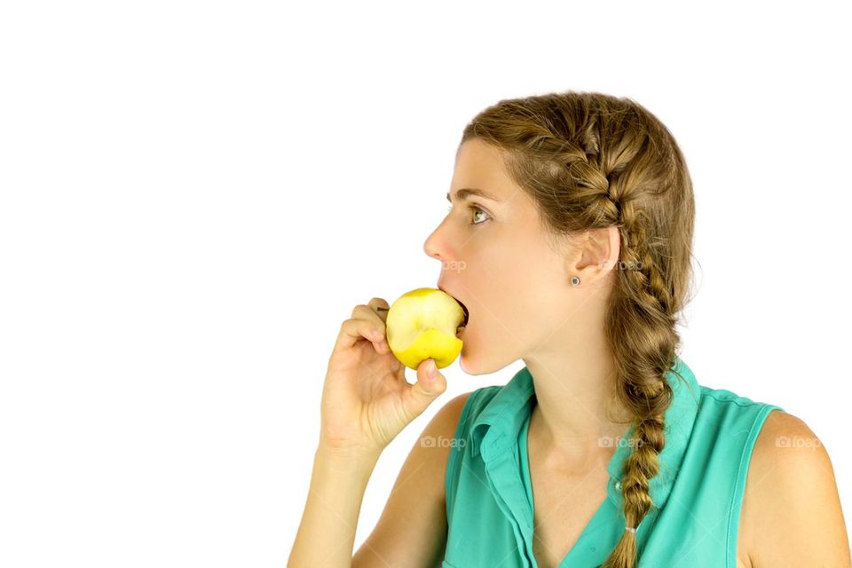 Girl taking a bite of an apple