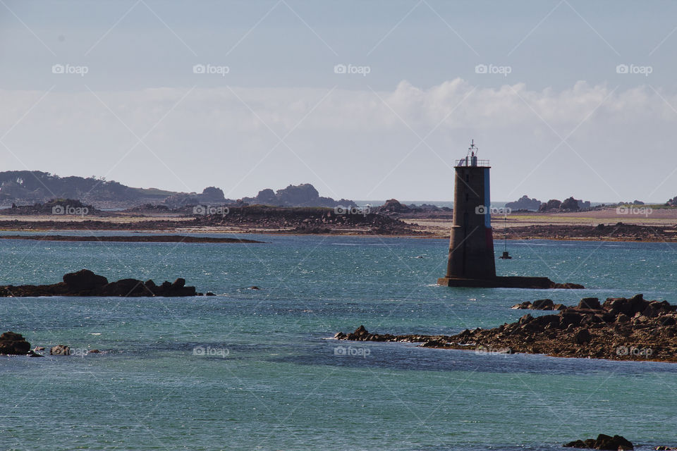 lighthouse on the shore of the sea