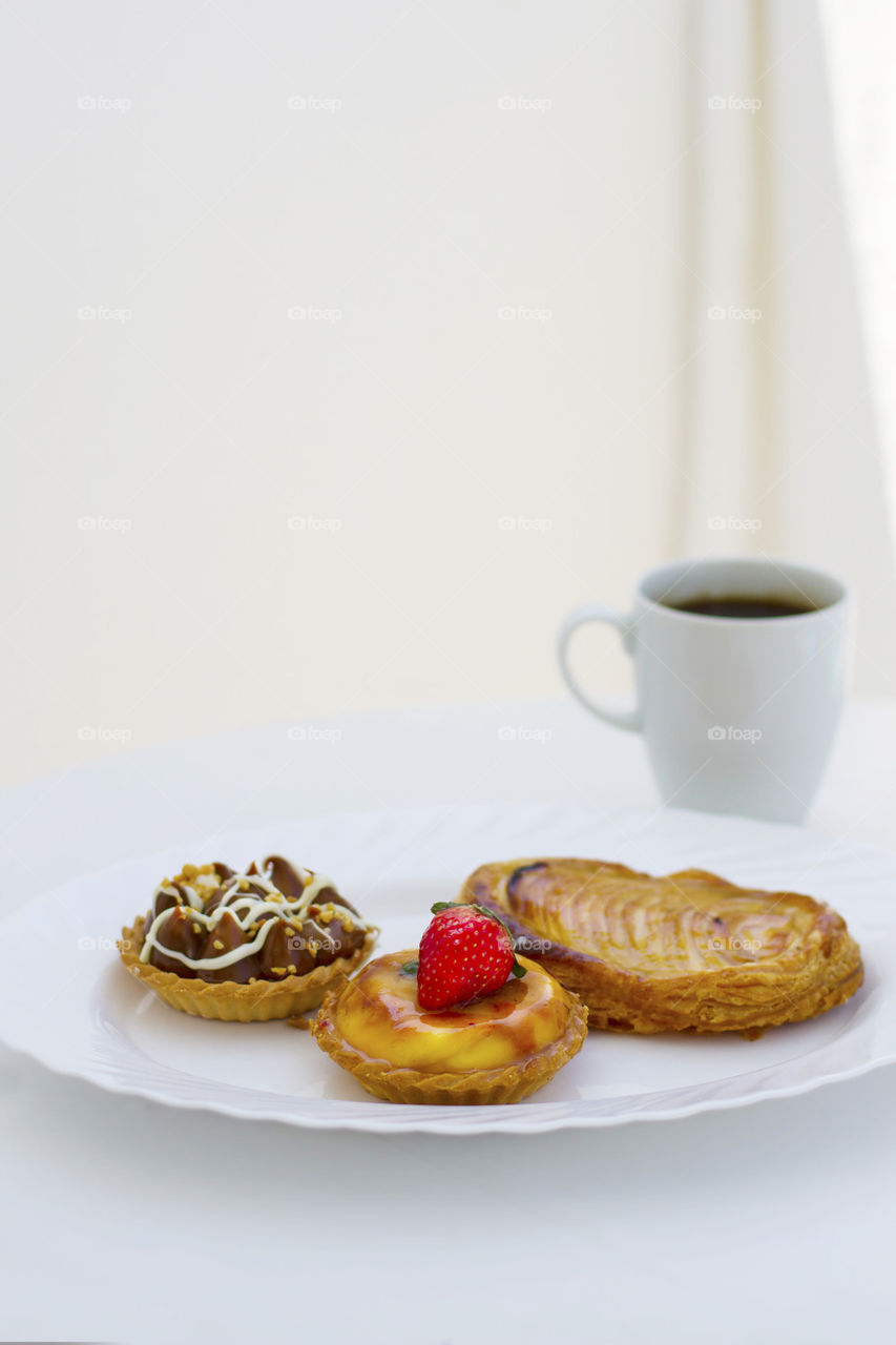 Tart with coffee on table