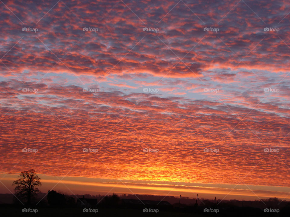 Stunning morning orange sunrise beneath the clouds.