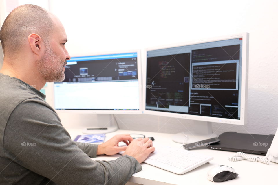 a man at his computer workplace