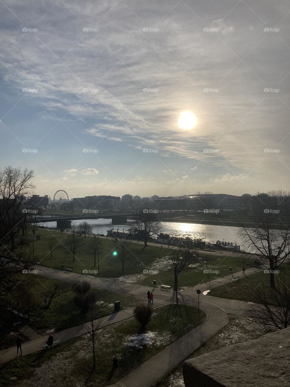 Wisla river before sunset. Sunny day perfect for sightseeing. Kraków city at night during Christmas time. Famous landmarks and Christmas tree. Sightseeing the city at night. Crowded evening on Christmas market.