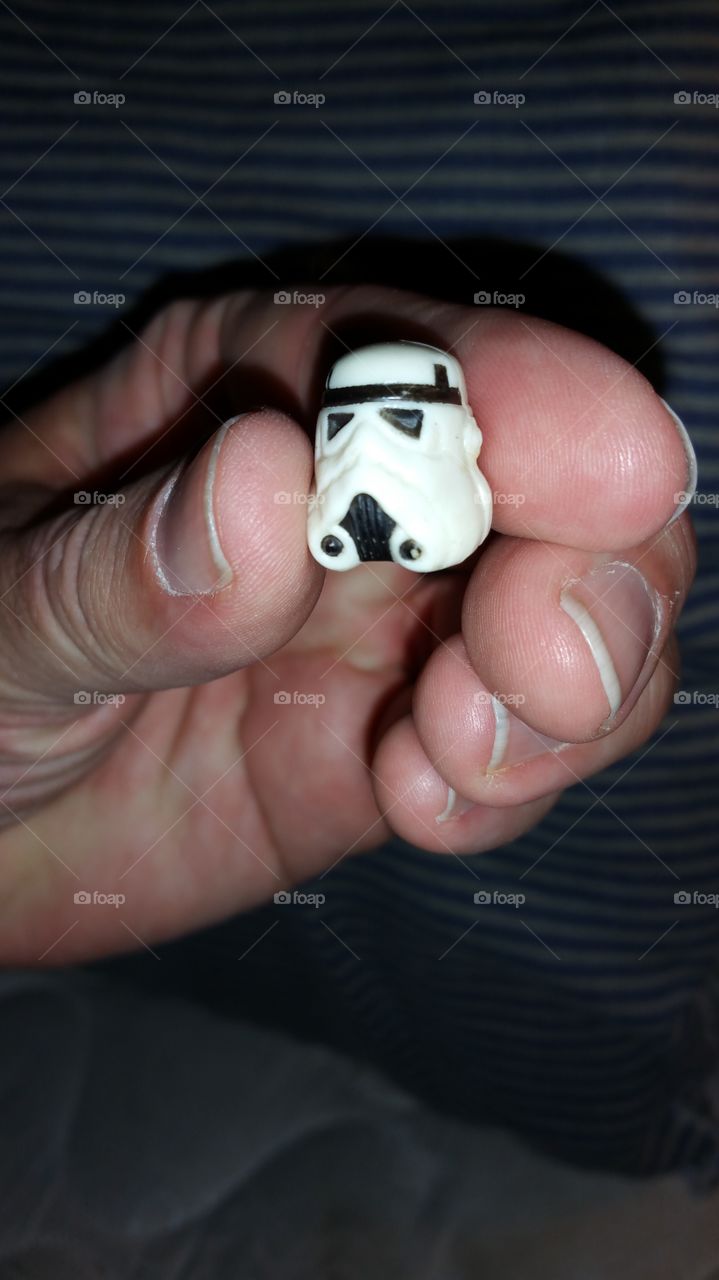 hand holding small Luke Skywalker helmet