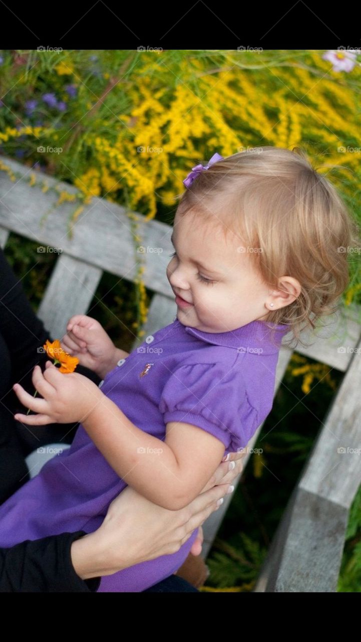 Little girl holding flower