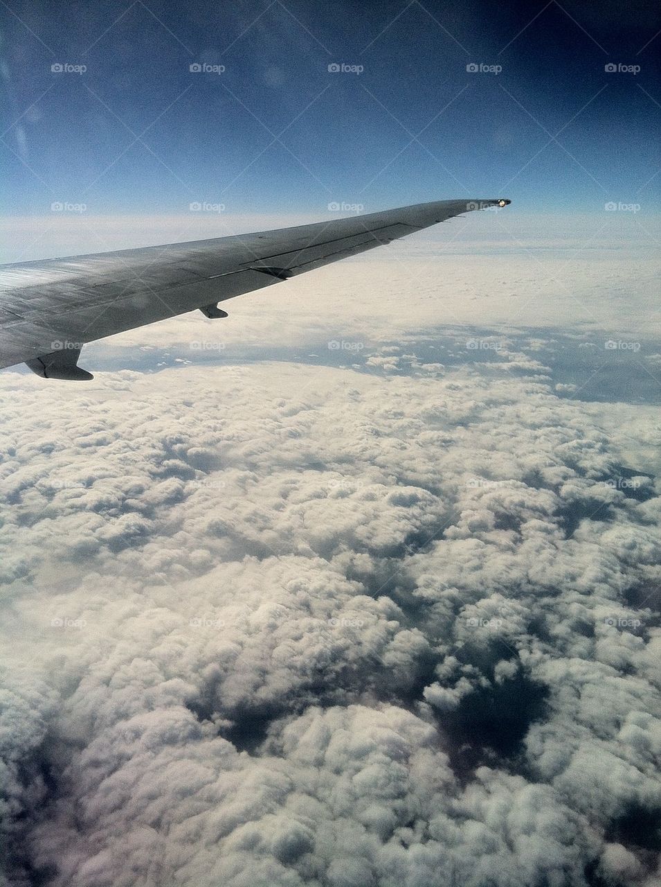Wing over clouds