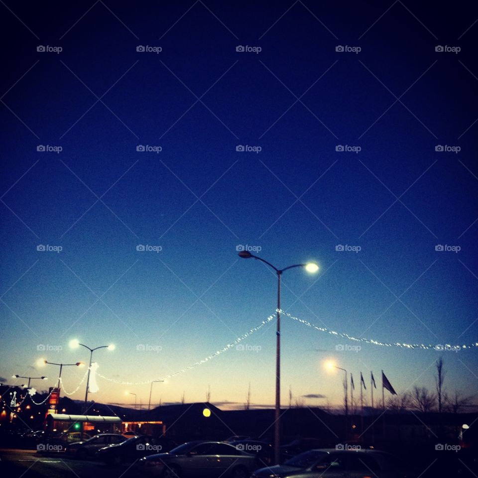 Twilight car park . Car park with fairy lights at dusk